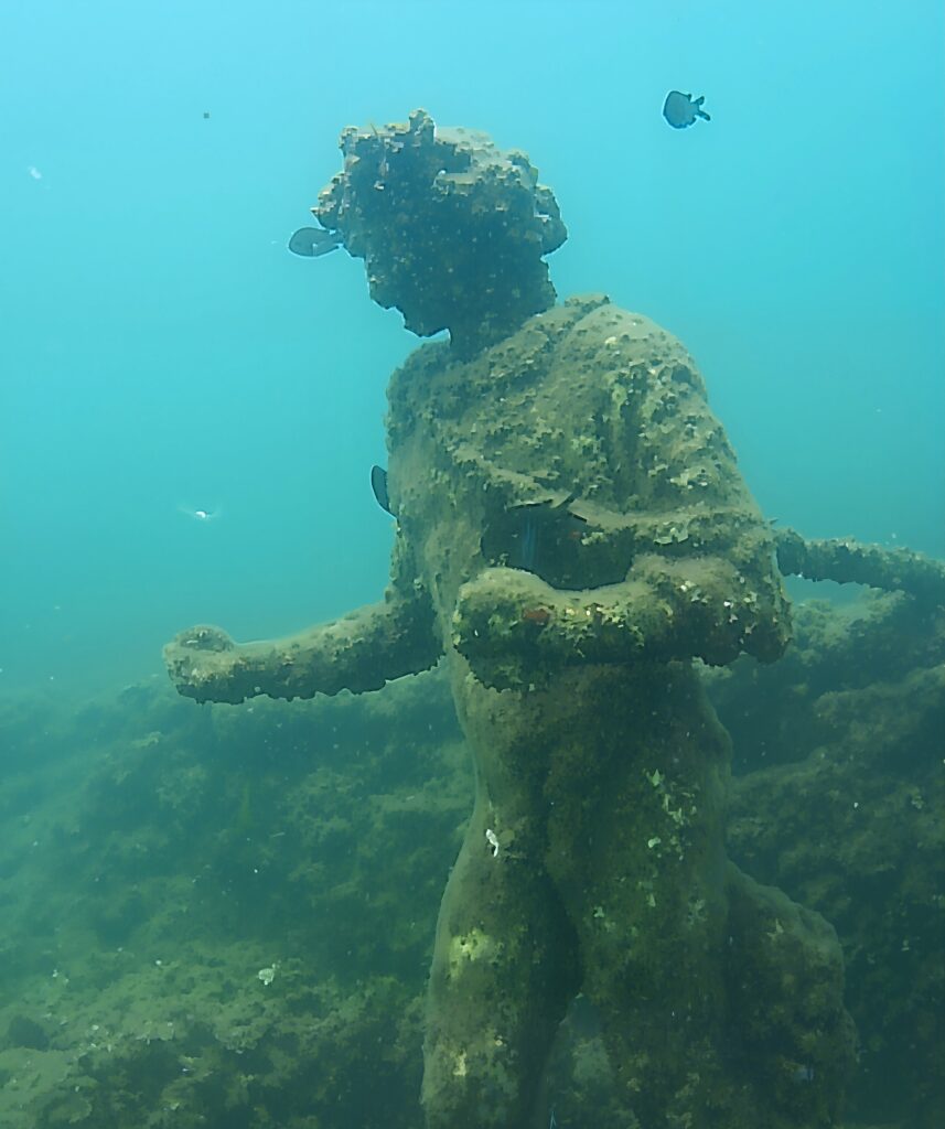 “Statua di Dioniso con corona d’edera dal Ninfeo di Punta Epitaffio, Parco archeologico sommerso di Baia nei Campi Flegrei.”
